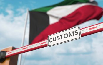 Closing boom barrier with customs sign against the kuwaiti flag. restricted border crossing or protective tariffs in kuwait.  3D rendering