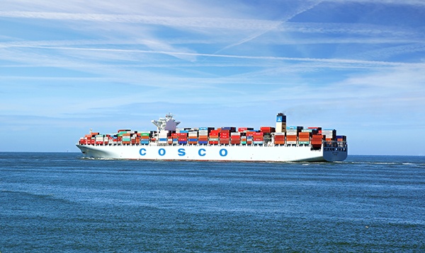 ROTTERDAM, NETHERLANDS - AUGUST 02: Container Ship COSCO with full of cargo from the port of Rotterdam. COSCO Group is the largest liner carrier in China on August 02, 2012 in Rotterdam Netherlands